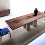 Rectangular wooden dining table with metal legs and two blue chairs